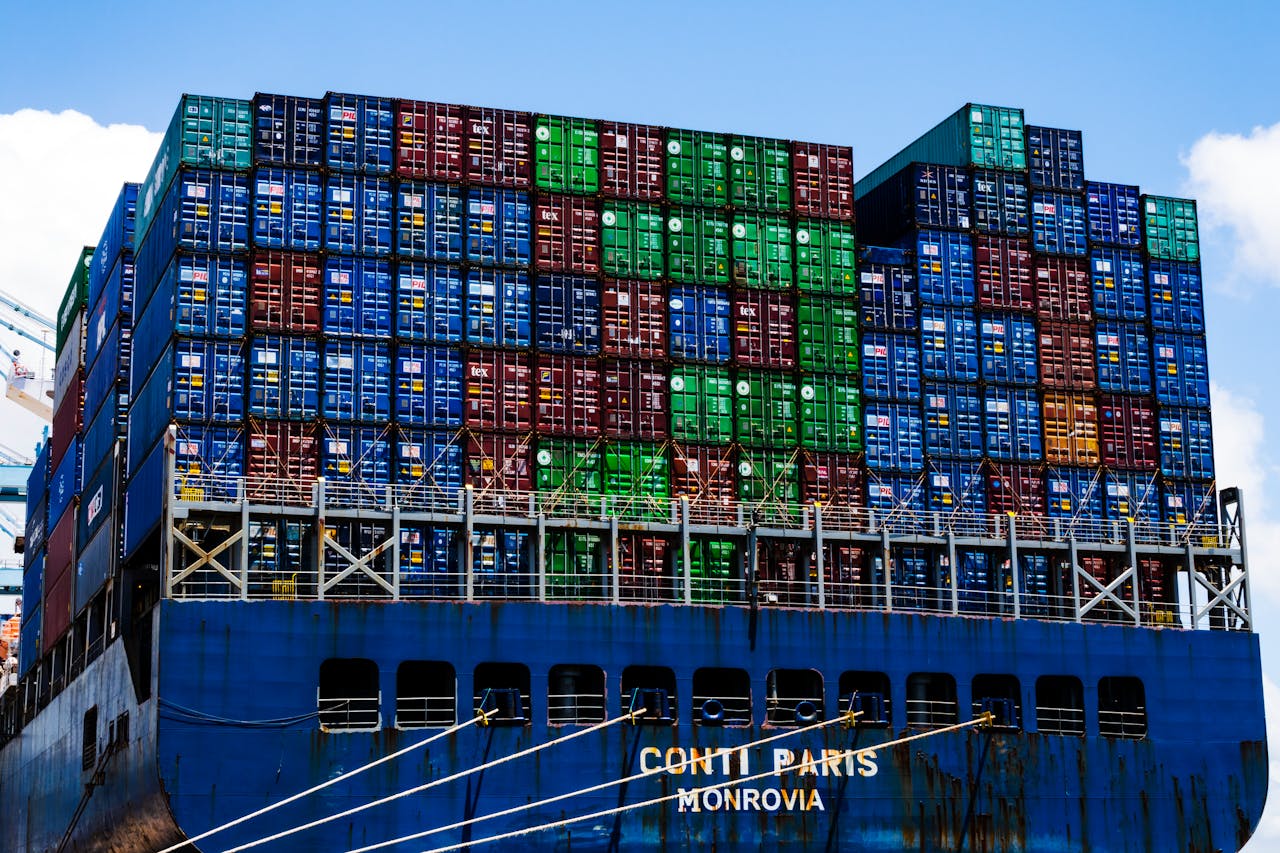 services-04 Stacked cargo containers on a massive ship at the harbor, symbolizing global trade.